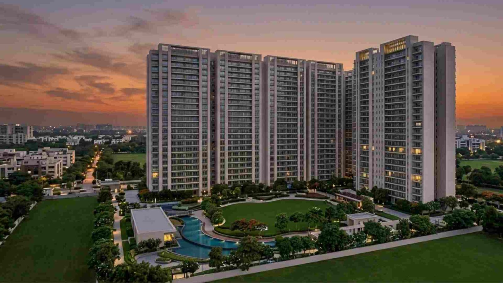 Architectural render of DLF The Arbour towers in Sector 63 Gurgaon showing luxury high-rise buildings, a large central green lawn, swimming pool, and landscaped gardens during sunset.